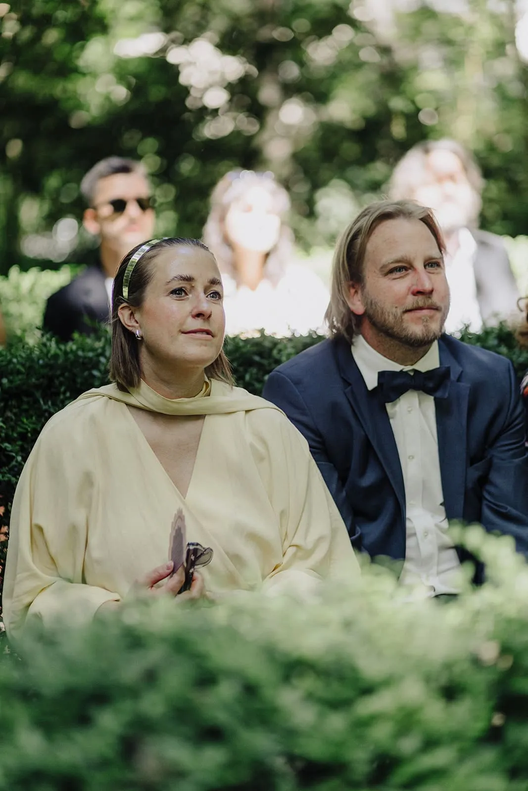 Two guests in the front row, listening